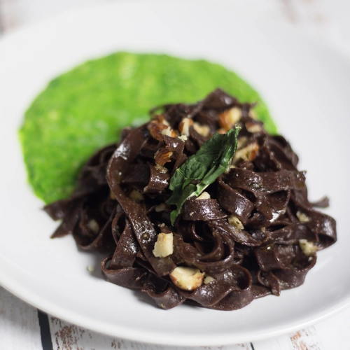 Cocoa tagliatelle with spinach and hazelnut pesto